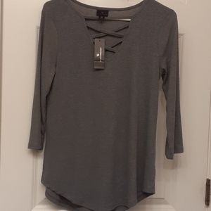 A Wortgington top woth a crisscros v-neck in front